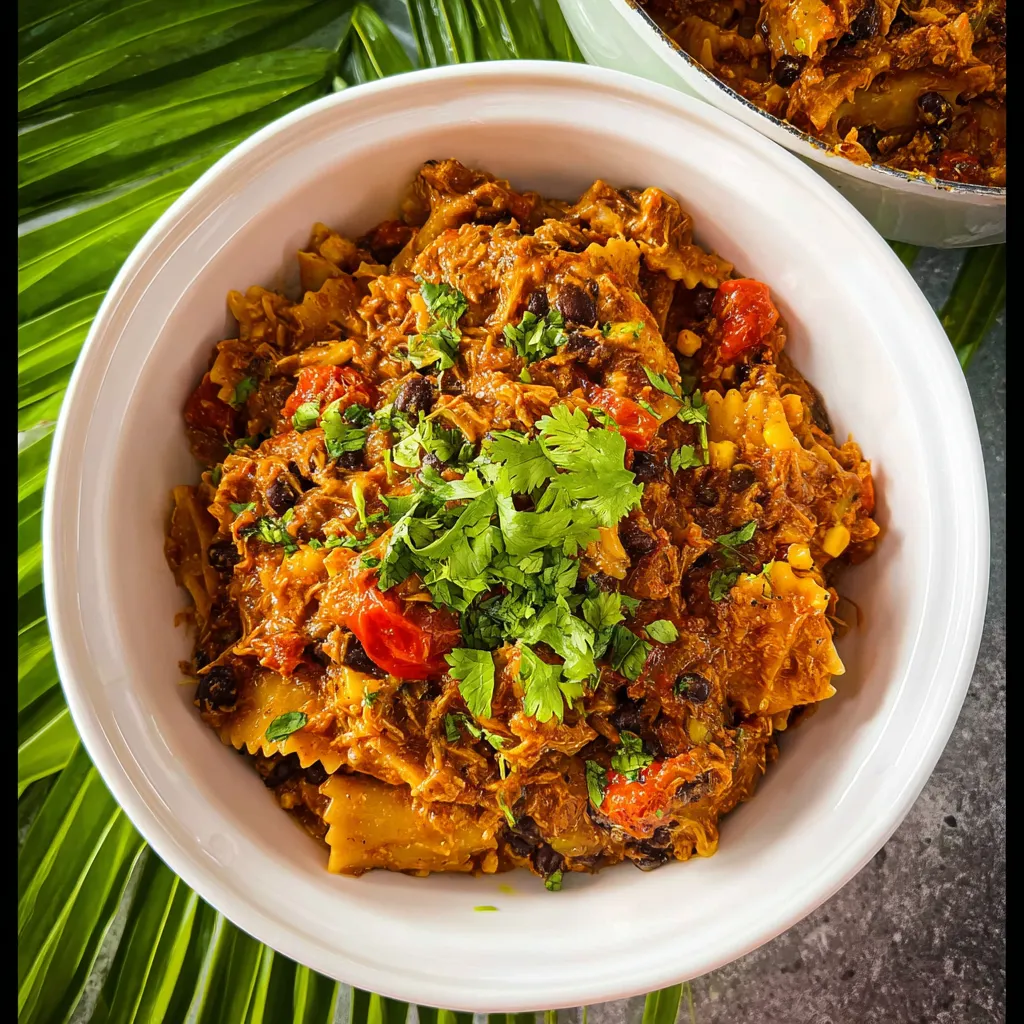 A bowl of food with a green topping.