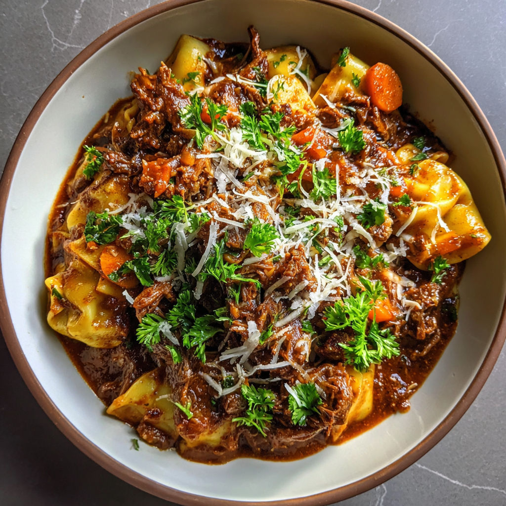 A bowl of food with meat and vegetables.