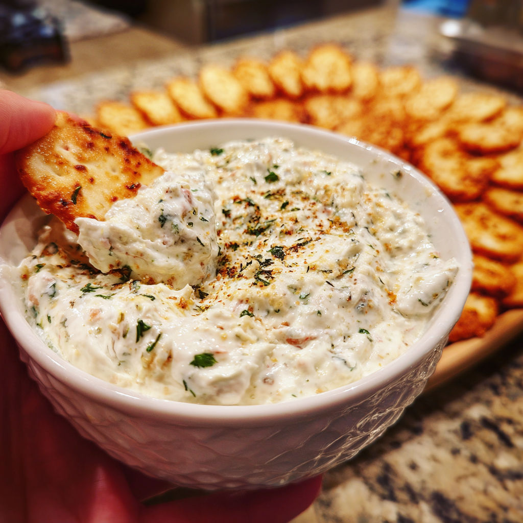 A hand holding a bowl of food.