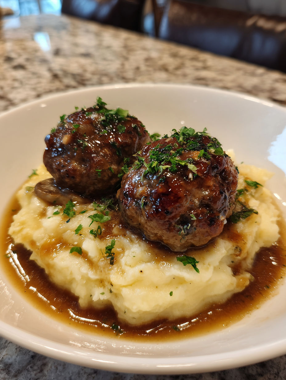 A plate of meatballs and mashed potatoes.