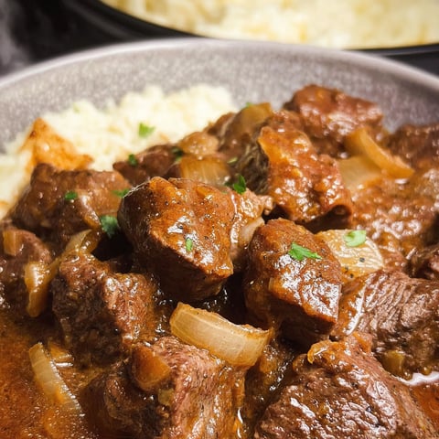 A close up of a plate of beef stew.