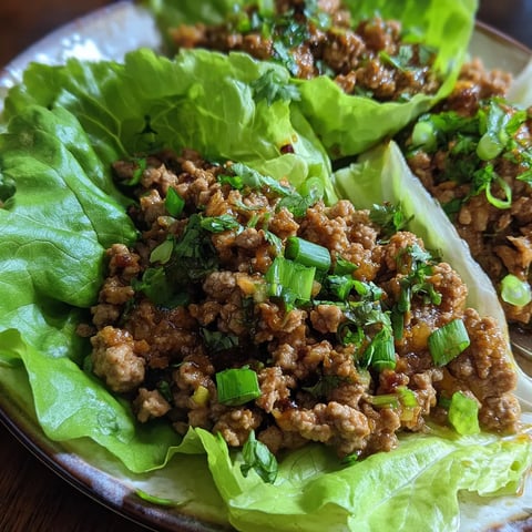 A plate of ground pork lettuce wraps.