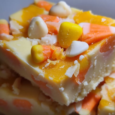 A close up of a piece of candy corn fudge.