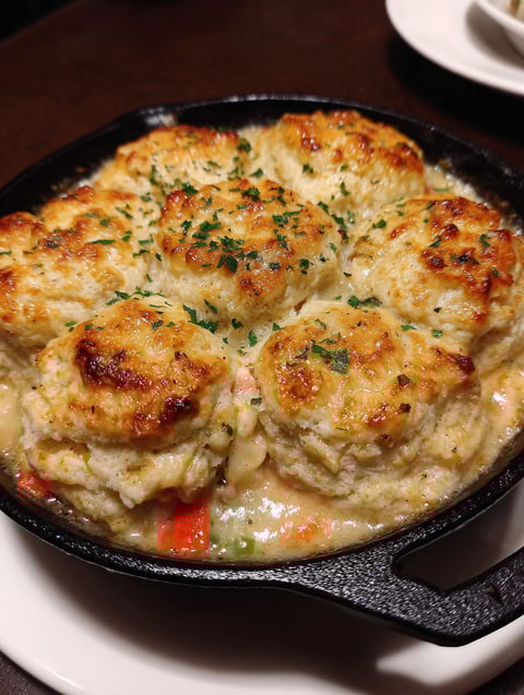 A dish of biscuits and chicken pot pie.